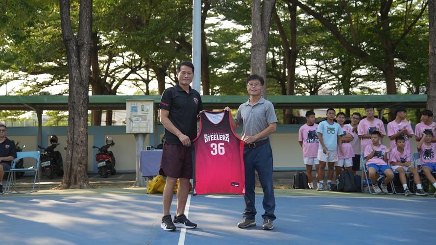 總教練邱大宗致贈球衣給陽明國中男籃總教練吳昌和。(圖/鋼鐵人提供)